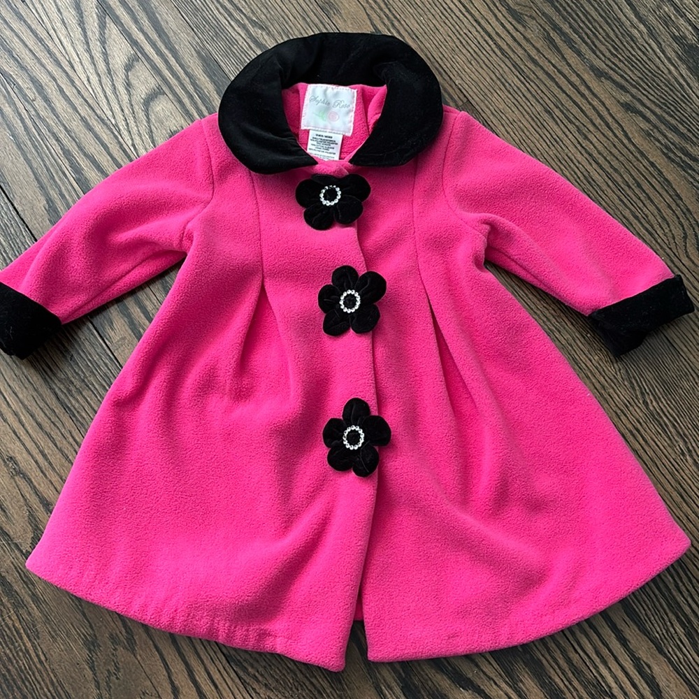 Brand new baby winter coat. Pink with black velvet cuffs and floral details.